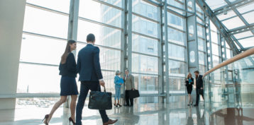 Business People Walking In Glass Building